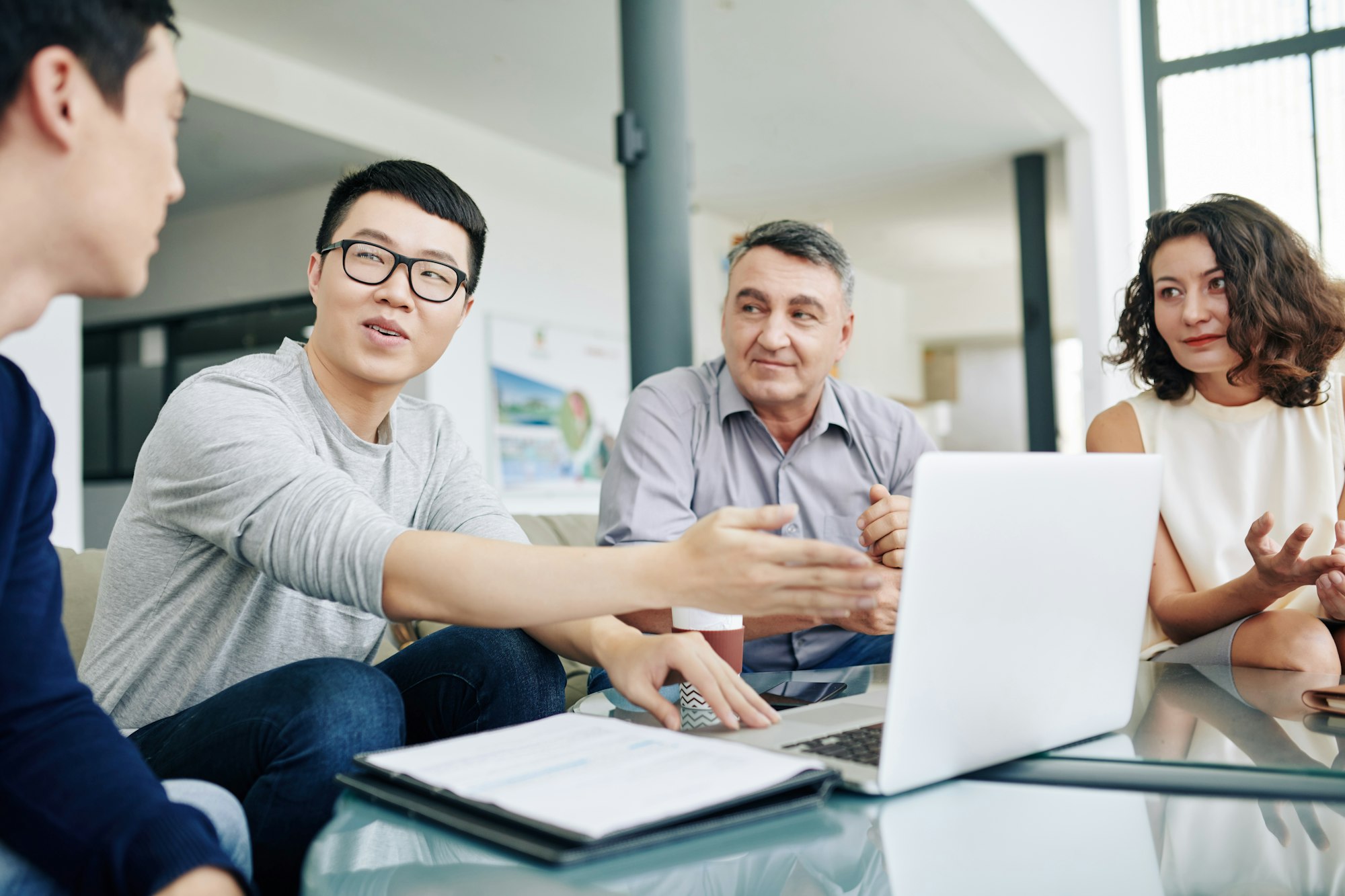 Entrepreneur showing report to colleagues