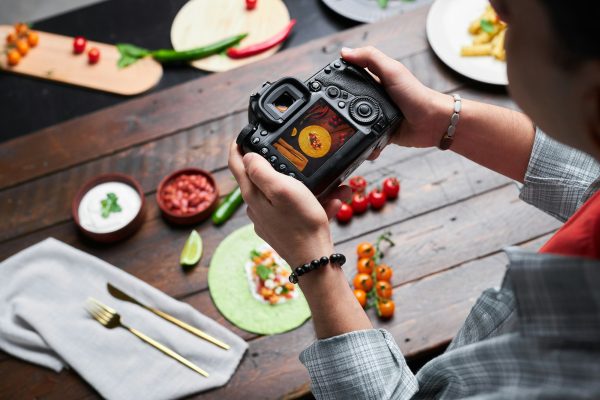 Man making photo of food on camera