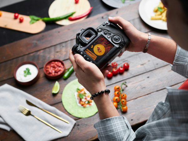 Man making photo of food on camera