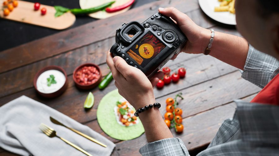 Man making photo of food on camera