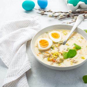 Traditional Polish sour soup Zurek in ceramic bowl for Easter