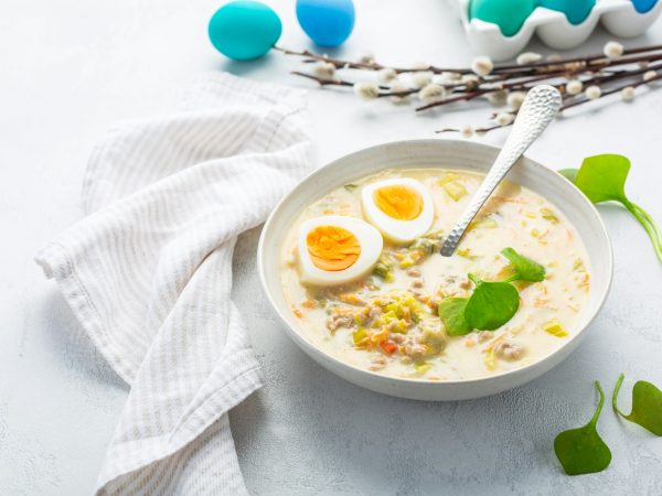 Traditional Polish sour soup Zurek in ceramic bowl for Easter