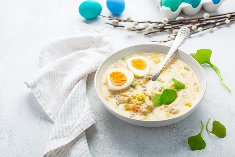 Traditional Polish sour soup Zurek in ceramic bowl for Easter